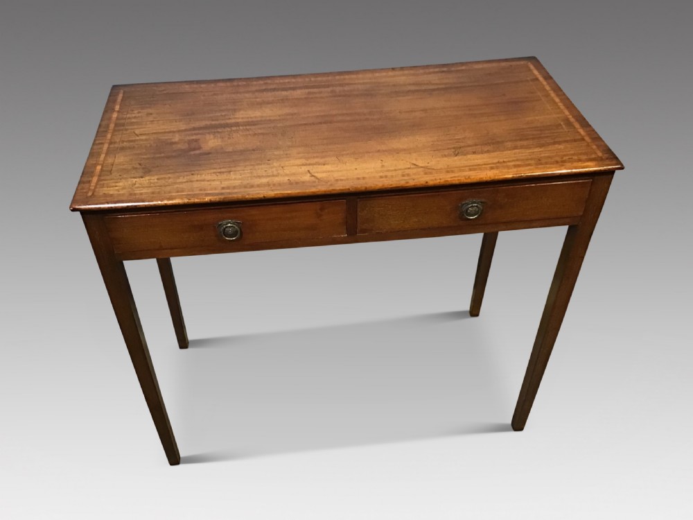 An antique Georgian mahogany side table featuring two drawer compartments with brass ring handles, boxwood inlaid border detail, and four square tapered legs.