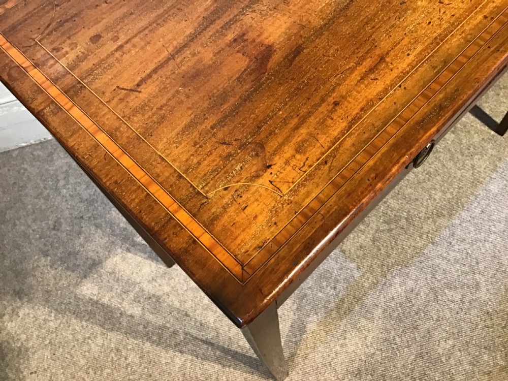 An antique Georgian mahogany side table featuring two drawer compartments with brass ring handles, boxwood inlaid border detail, and four square tapered legs. View VII