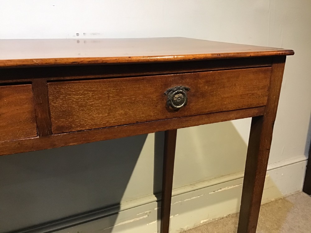 An antique Georgian mahogany side table featuring two drawer compartments with brass ring handles, boxwood inlaid border detail, and four square tapered legs. View IX