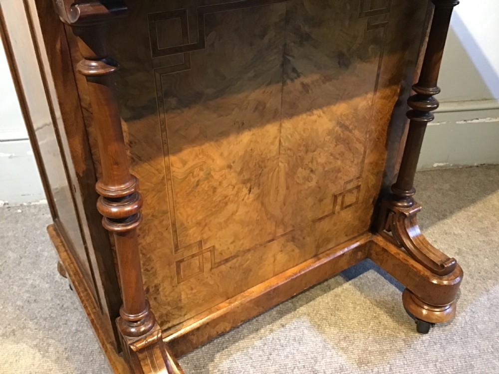 A Victorian burr walnut Davenport desk featuring a sloped leather writing surface, inlaid wood corner detailing, turned front supports, and a top stationery compartment. View VIII