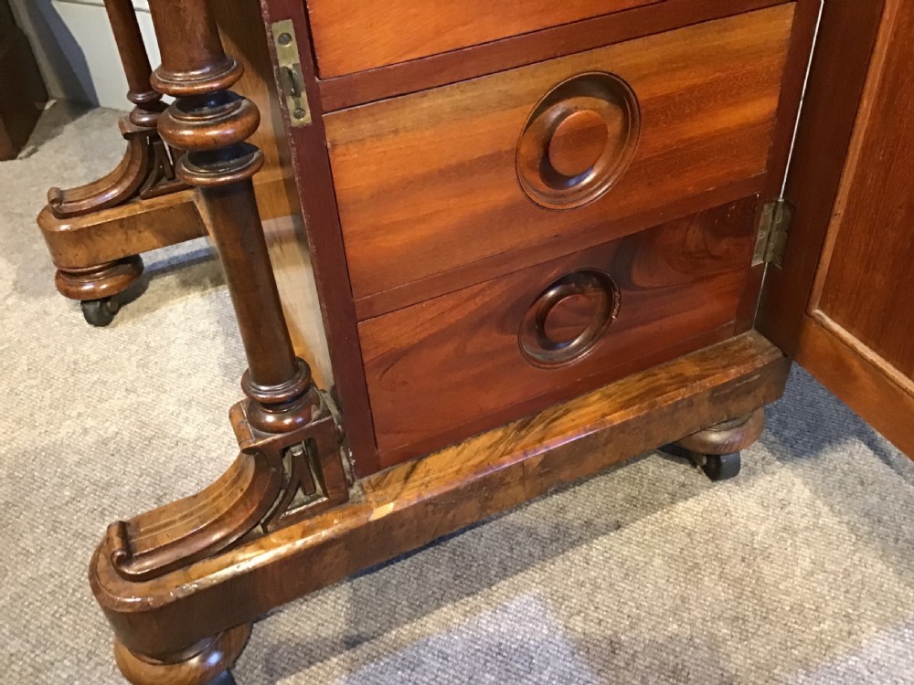 A Victorian burr walnut Davenport desk featuring a sloped leather writing surface, inlaid wood corner detailing, turned front supports, and a top stationery compartment. View XIII