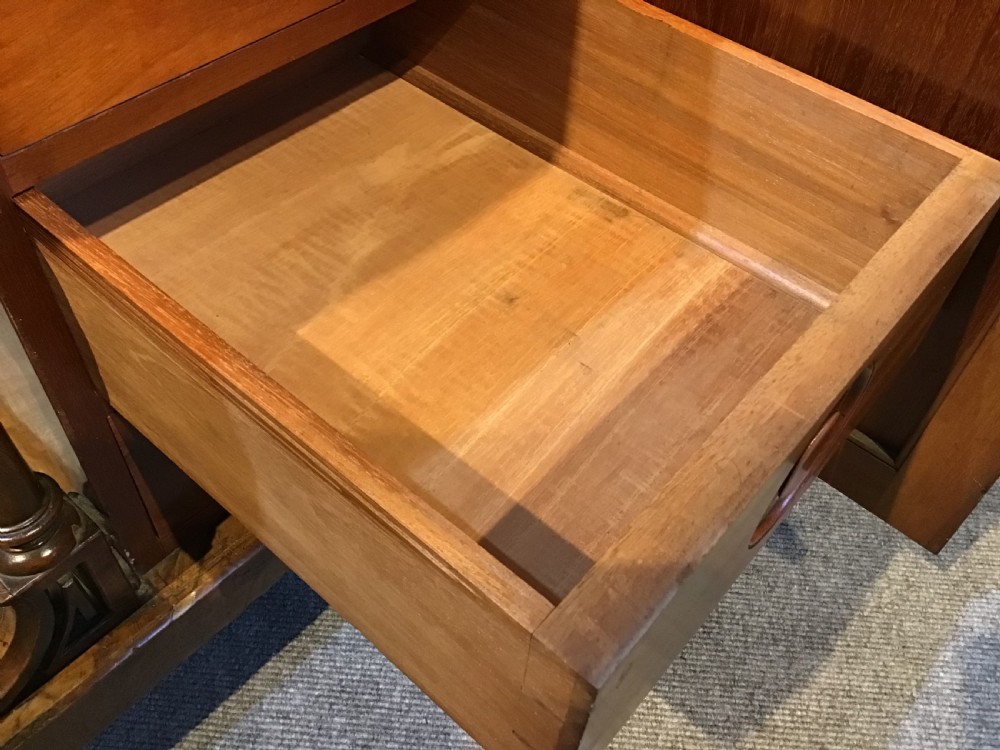 A Victorian burr walnut Davenport desk featuring a sloped leather writing surface, inlaid wood corner detailing, turned front supports, and a top stationery compartment. View XIV