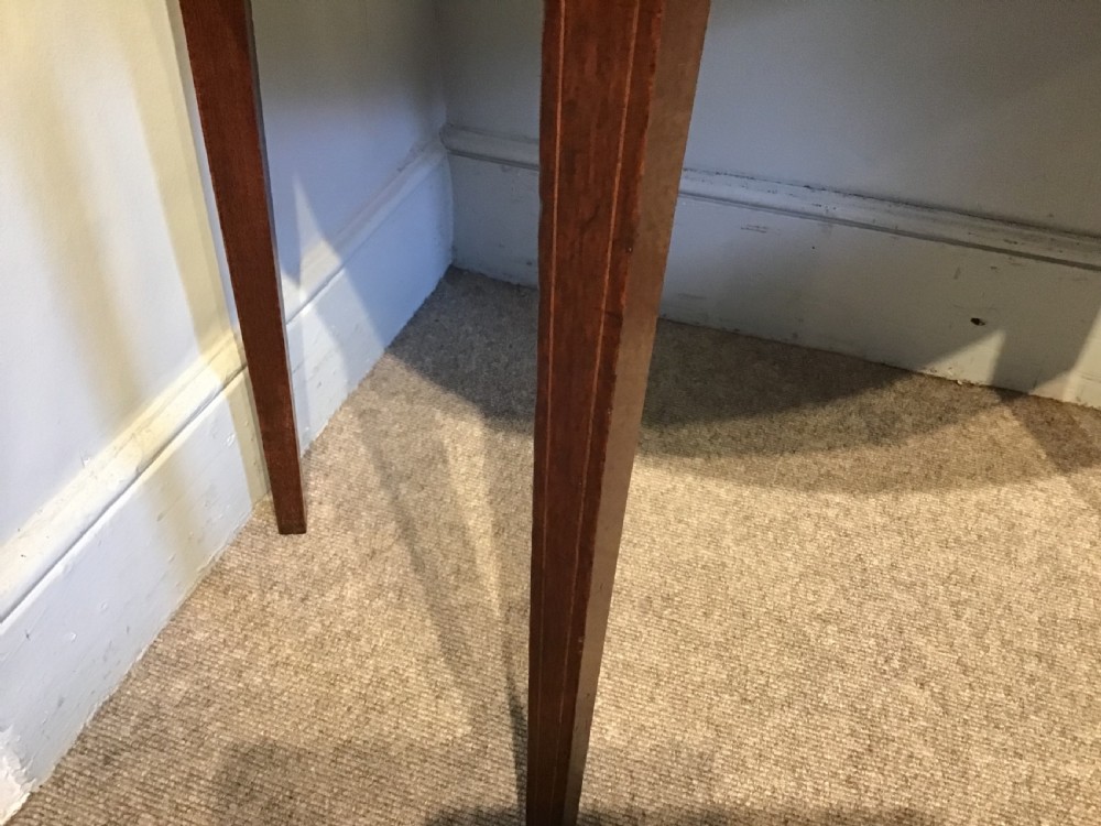 A Georgian dark mahogany demi-lune console table featuring a semicircular top with a central fan inlay motif and square tapered legs. View VII