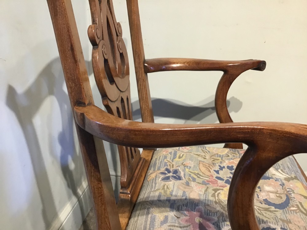 A George III mahogany elbow chair featuring a pierced scroll splat back, shaped armrests, and a multi-coloured floral tapestry drop-in seat. View VIII