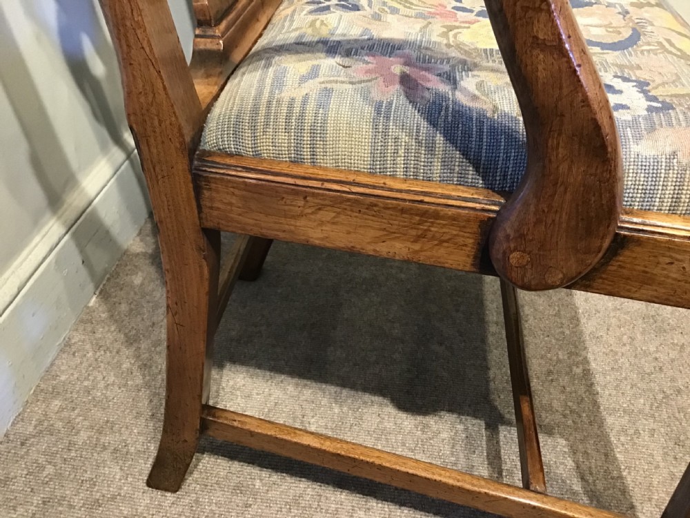 A George III mahogany elbow chair featuring a pierced scroll splat back, shaped armrests, and a multi-coloured floral tapestry drop-in seat. View IX