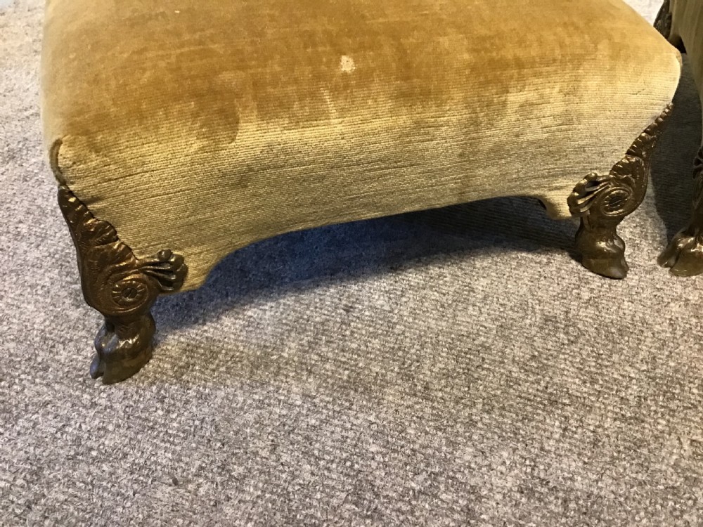 A pair of low rectangular antique footstools upholstered in mustard gold velvet with ornate carved cabriole legs. View III