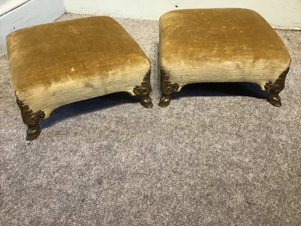 A pair of low rectangular antique footstools upholstered in mustard gold velvet with ornate carved cabriole legs. View IV