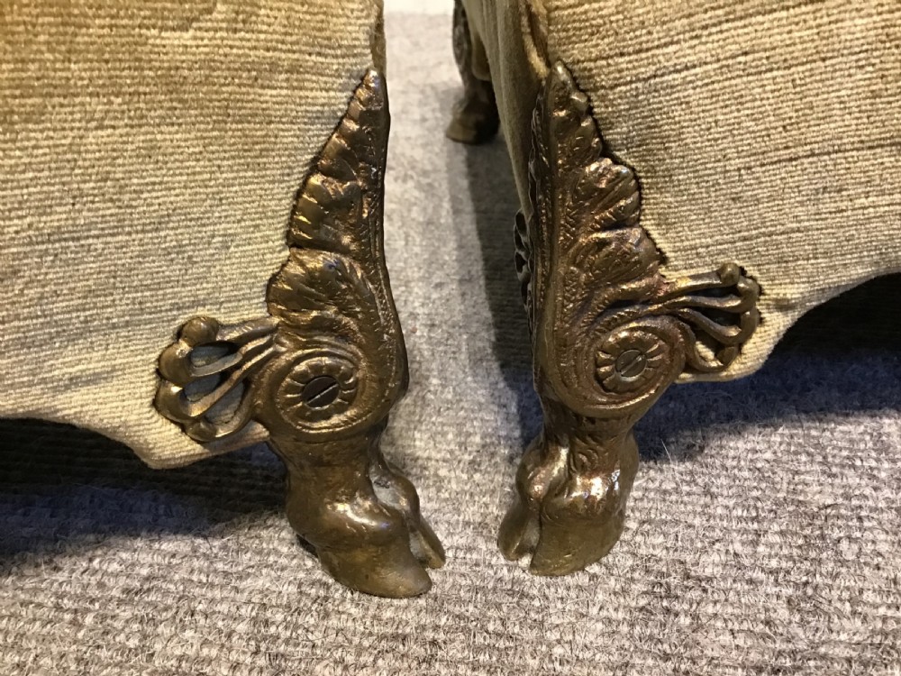 A pair of low rectangular antique footstools upholstered in mustard gold velvet with ornate carved cabriole legs. View V