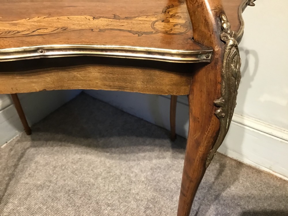 A two-tiered French etagere table featuring floral marquetry inlay, decorative brass mounts, and slender cabriole legs. View V