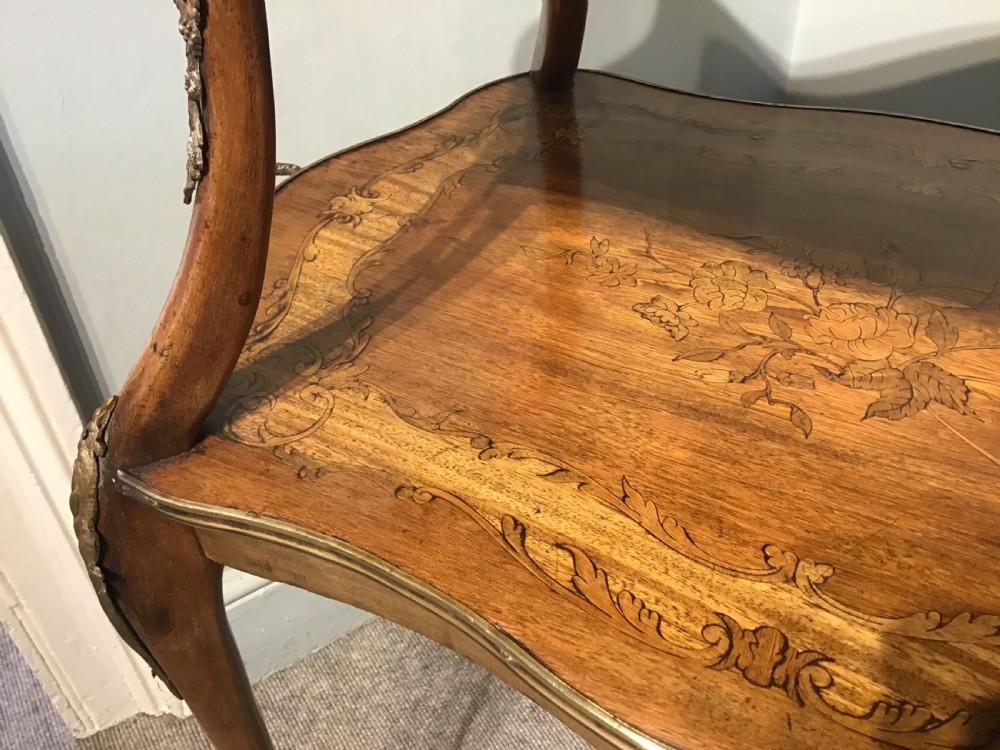 A two-tiered French etagere table featuring floral marquetry inlay, decorative brass mounts, and slender cabriole legs. View VII
