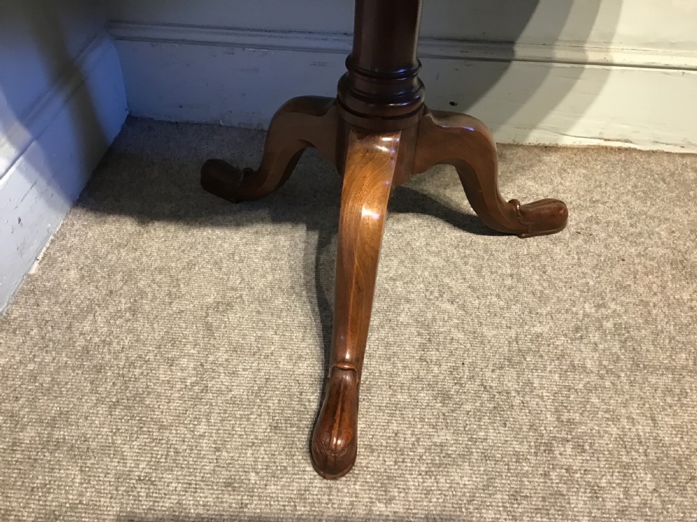 An antique mahogany two-tiered dumb waiter featuring scalloped tray edges, a turned central column, and a tripod base. View V