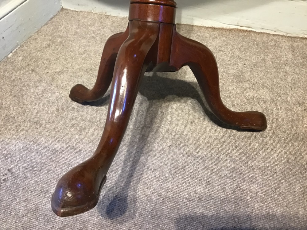 A dark mahogany circular tripod table with a turned central column featuring spiral carving and three cabriole legs with pad feet. View VI
