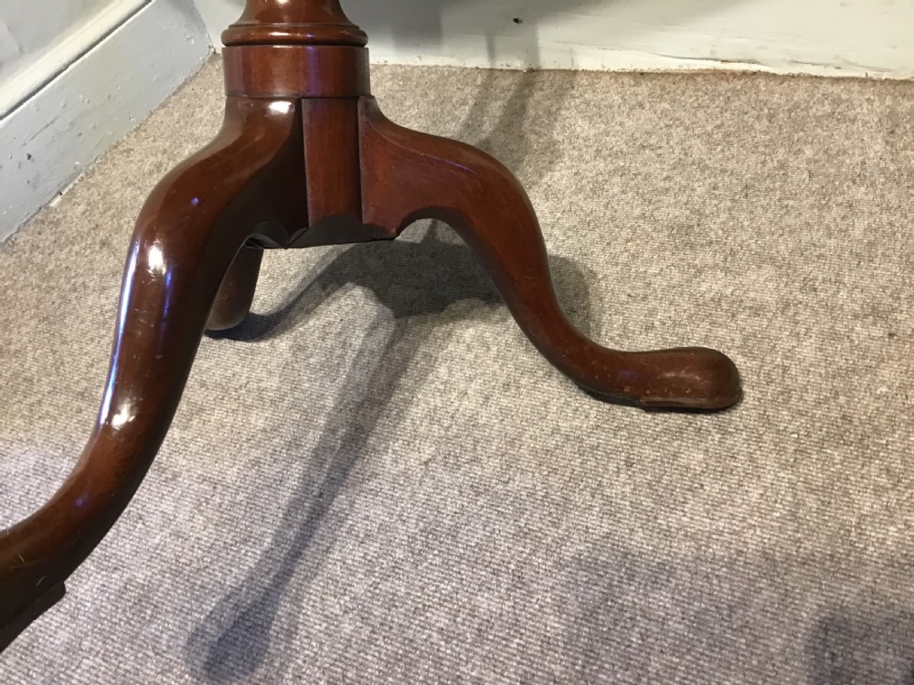A dark mahogany circular tripod table with a turned central column featuring spiral carving and three cabriole legs with pad feet. View VII