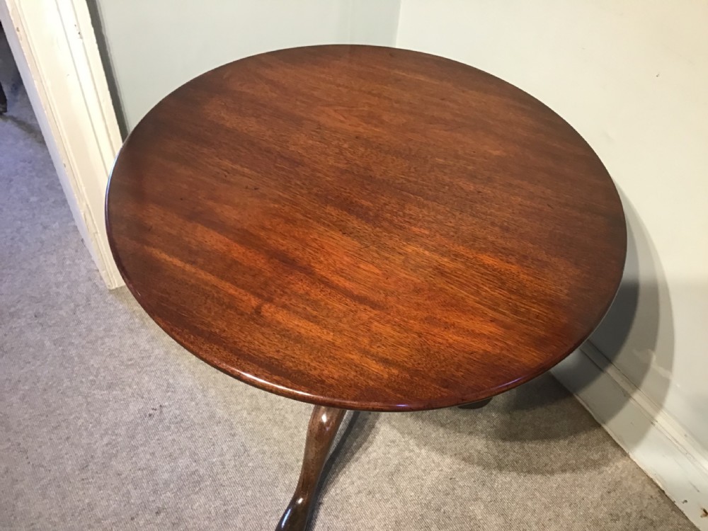 An 18th-century Georgian mahogany tripod table featuring a circular top, a central turned pedestal column, and three splayed cabriole legs. View II