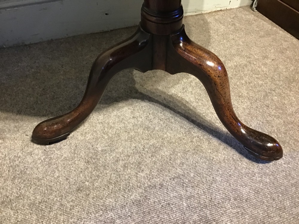 An 18th-century Georgian mahogany tripod table featuring a circular top, a central turned pedestal column, and three splayed cabriole legs. View IV