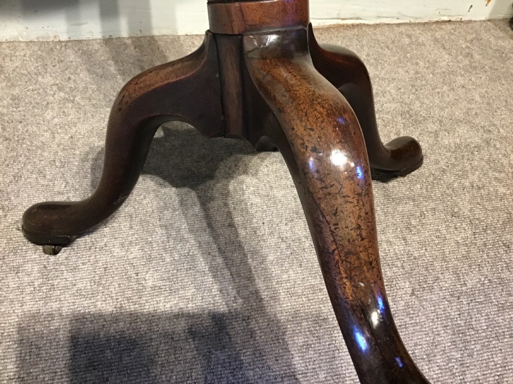 An 18th-century Georgian mahogany tripod table featuring a circular top, a central turned pedestal column, and three splayed cabriole legs. View VI