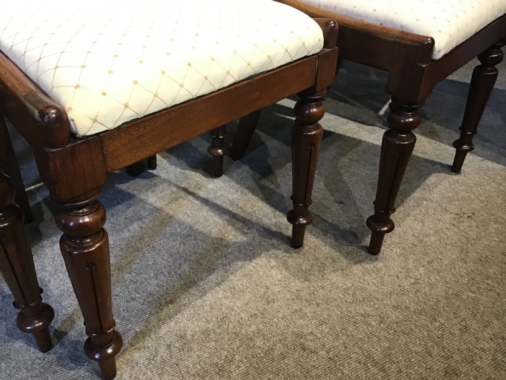 A set of eight Victorian mahogany balloon back dining chairs featuring turned front legs and light cream patterned upholstered seats. View III