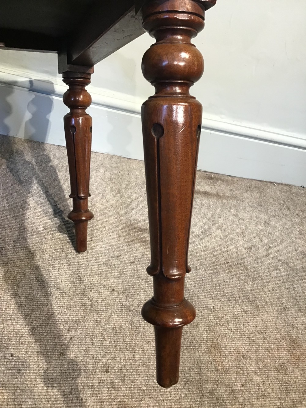 A set of eight Victorian mahogany balloon back dining chairs featuring turned front legs and light cream patterned upholstered seats. View X
