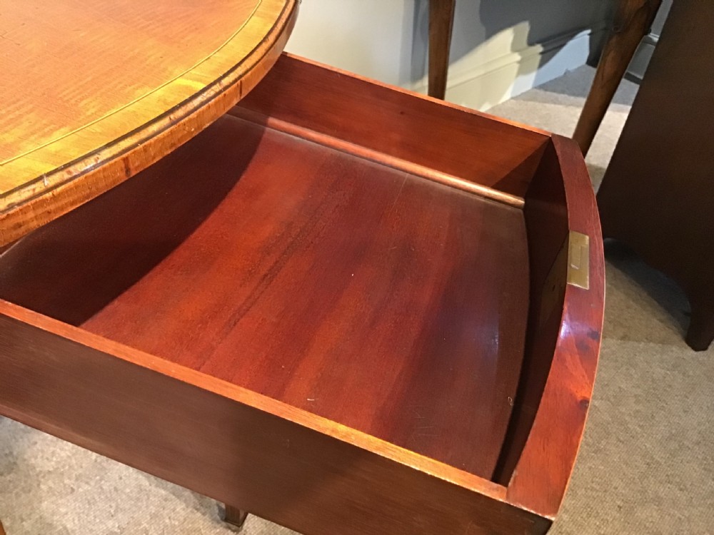An antique Georgian mahogany Pembroke table with two folded drop leaves, satinwood stringing inlay, and slender square tapered legs. View VI