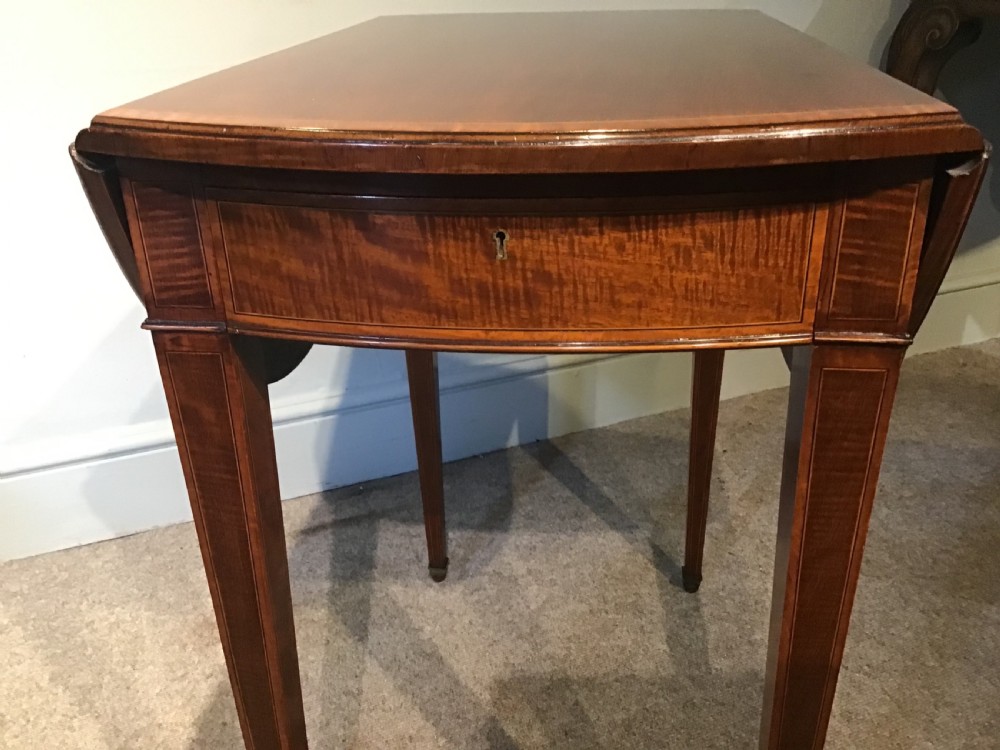An antique Georgian mahogany Pembroke table with two folded drop leaves, satinwood stringing inlay, and slender square tapered legs. View VIII