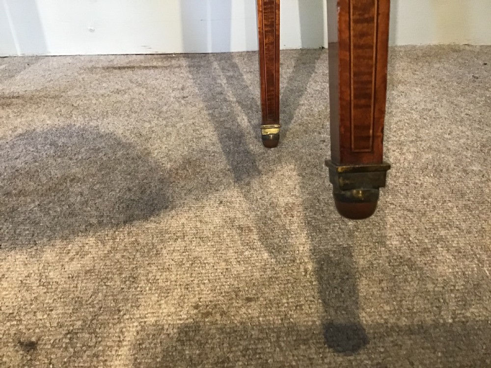 An antique Georgian mahogany Pembroke table with two folded drop leaves, satinwood stringing inlay, and slender square tapered legs. View XI