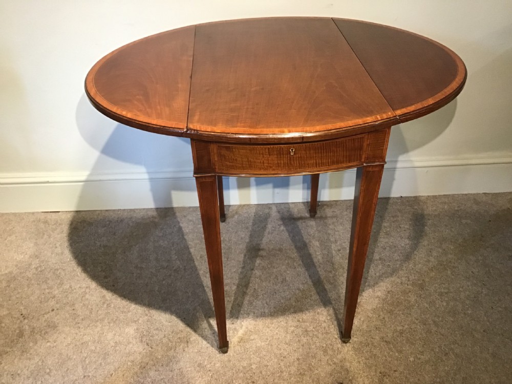 An antique Georgian mahogany Pembroke table with two folded drop leaves, satinwood stringing inlay, and slender square tapered legs. View XII