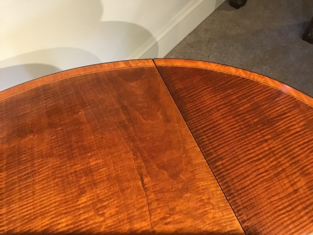 An antique Georgian mahogany Pembroke table with two folded drop leaves, satinwood stringing inlay, and slender square tapered legs. View XIV