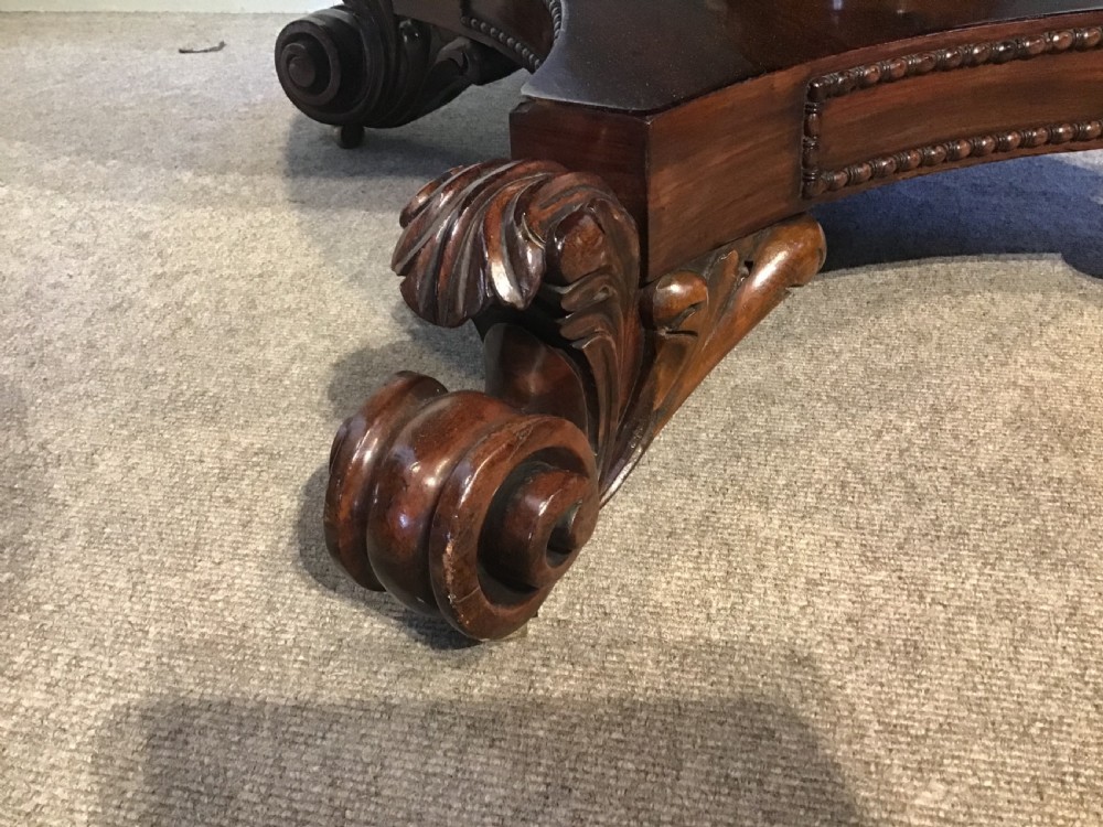 A circular antique Goncalo Alves centre table featuring a figured timber top and a pedestal base with carved scroll feet. View III