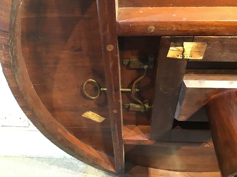 A circular antique Goncalo Alves centre table featuring a figured timber top and a pedestal base with carved scroll feet. View XII