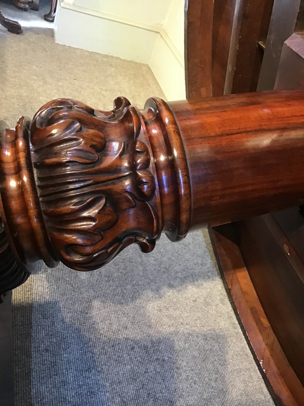 A circular antique Goncalo Alves centre table featuring a figured timber top and a pedestal base with carved scroll feet. View XIII