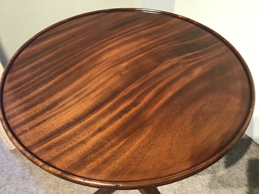 An antique mahogany low tripod table View IV