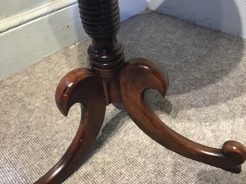 An antique mahogany low tripod table View VI