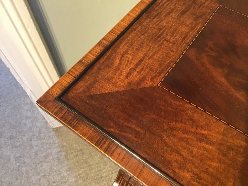 A set of four graduated dark mahogany nested tables featuring turned legs, curved rear stretchers, and splayed feet. View X