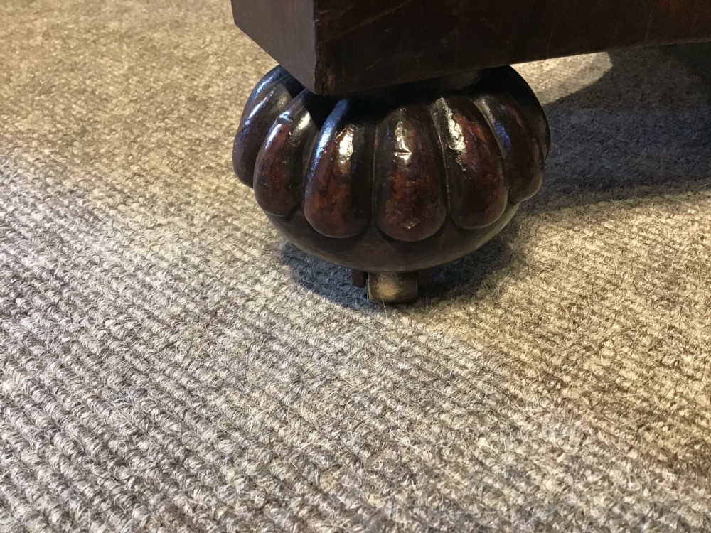 An antique rosewood fold-over card table with a beaded frieze, central turned pedestal stem, and a quadripartite plinth base on carved feet. View VI