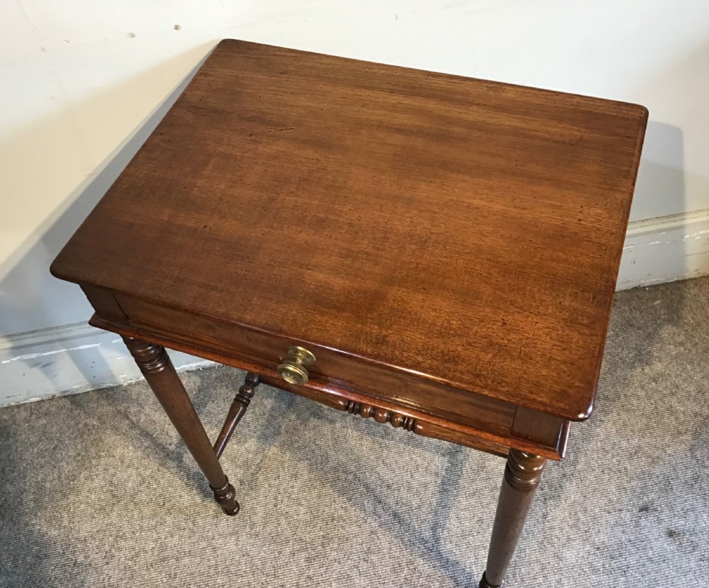 A Regency mahogany side table with a rectangular top, single drawer with brass pull, turned legs, and lower stretchers. View III