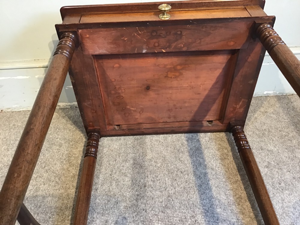 A Regency mahogany side table with a rectangular top, single drawer with brass pull, turned legs, and lower stretchers. View X
