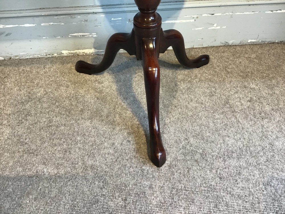 A dark mahogany Georgian tripod table with a canted rectangular top, central turned column, and three cabriole legs. View IV