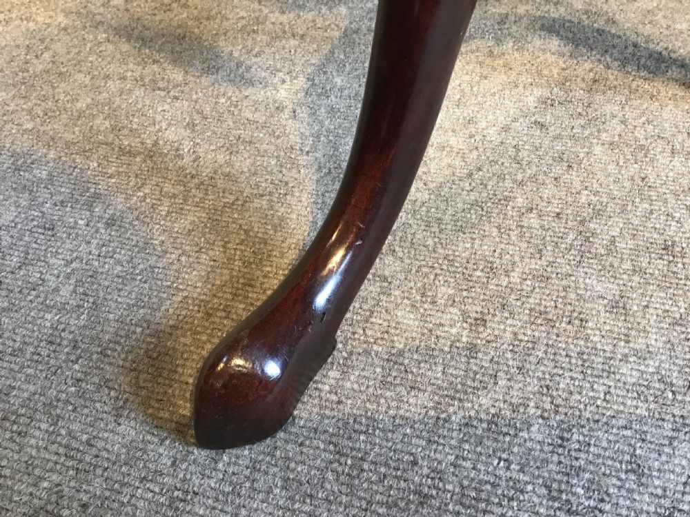 A dark mahogany Georgian tripod table with a canted rectangular top, central turned column, and three cabriole legs. View VII