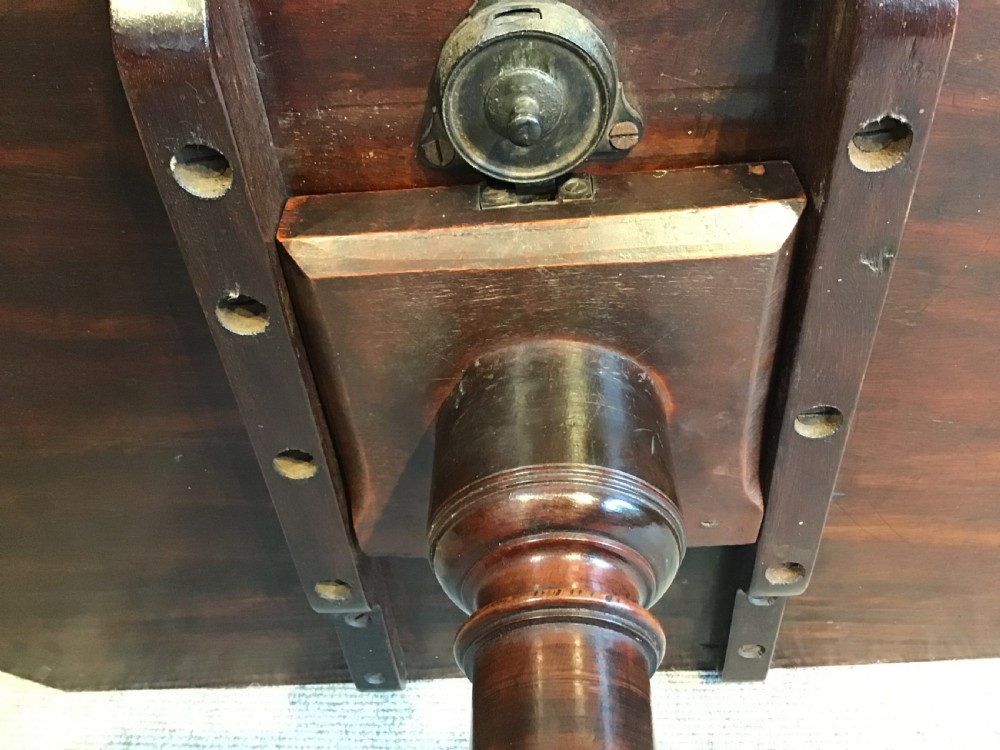 A dark mahogany Georgian tripod table with a canted rectangular top, central turned column, and three cabriole legs. View VIII