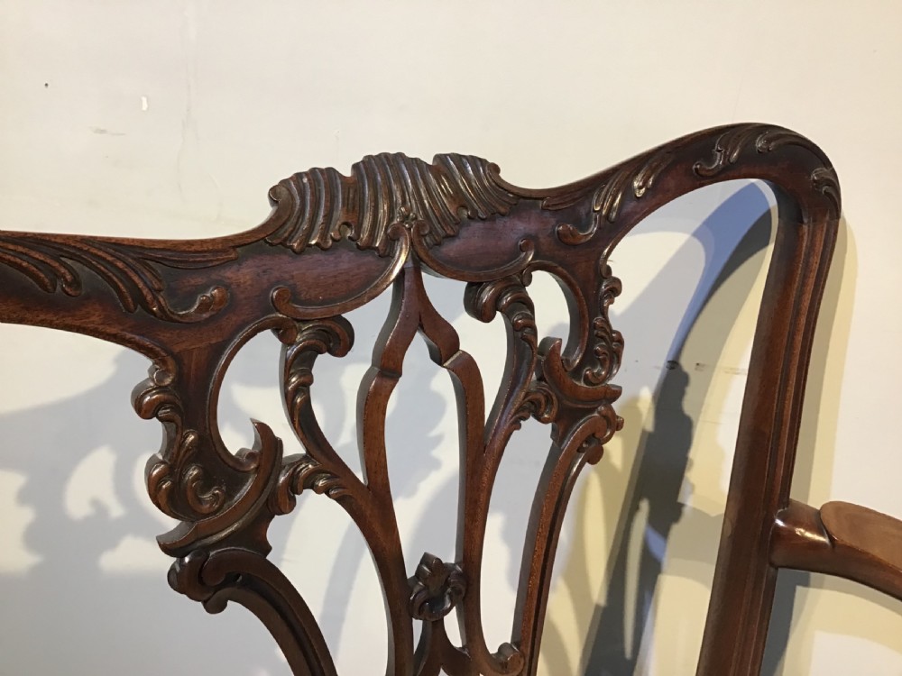 A set of eight Georgian mahogany dining chairs featuring intricate carved pierced back splats and cream patterned upholstered seats. View VII