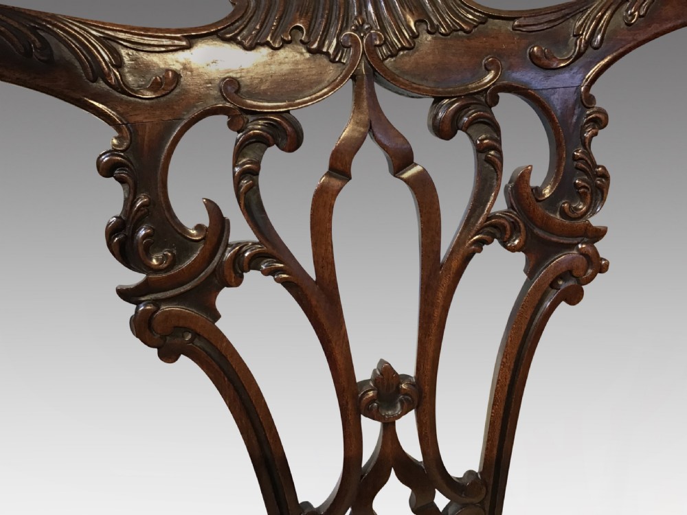 A set of eight Georgian mahogany dining chairs featuring intricate carved pierced back splats and cream patterned upholstered seats. View IX