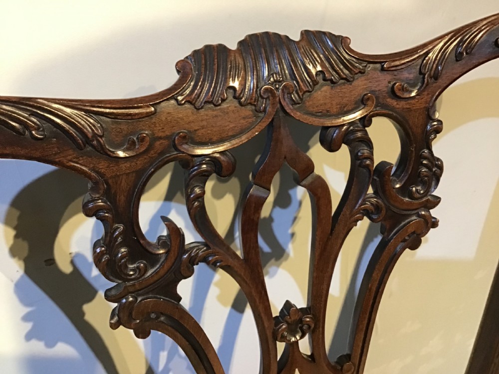A set of eight Georgian mahogany dining chairs featuring intricate carved pierced back splats and cream patterned upholstered seats. View XI