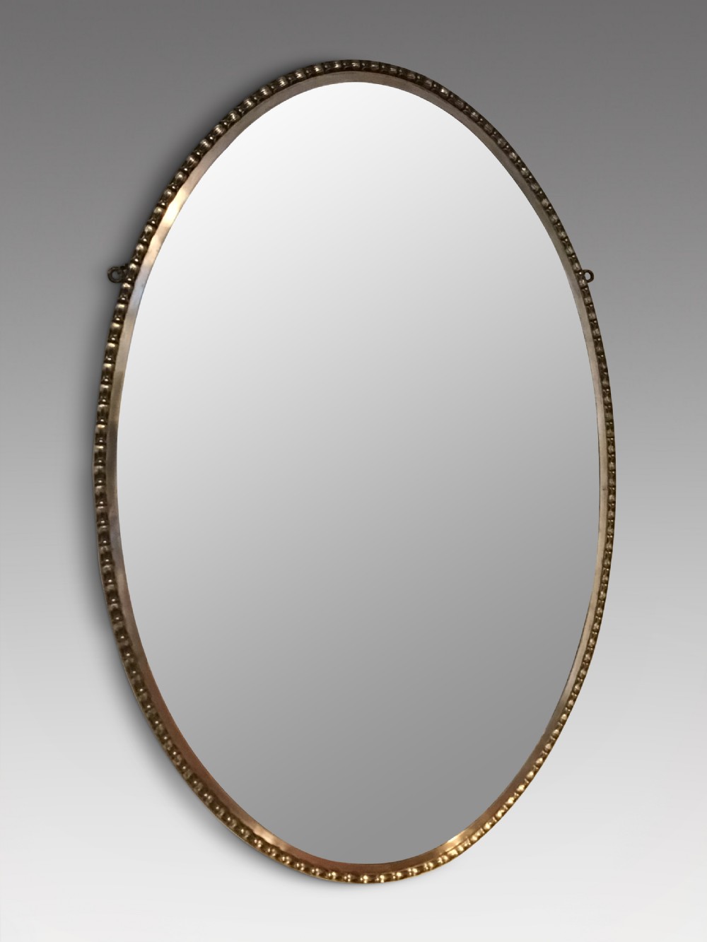 An antique brass framed mirror