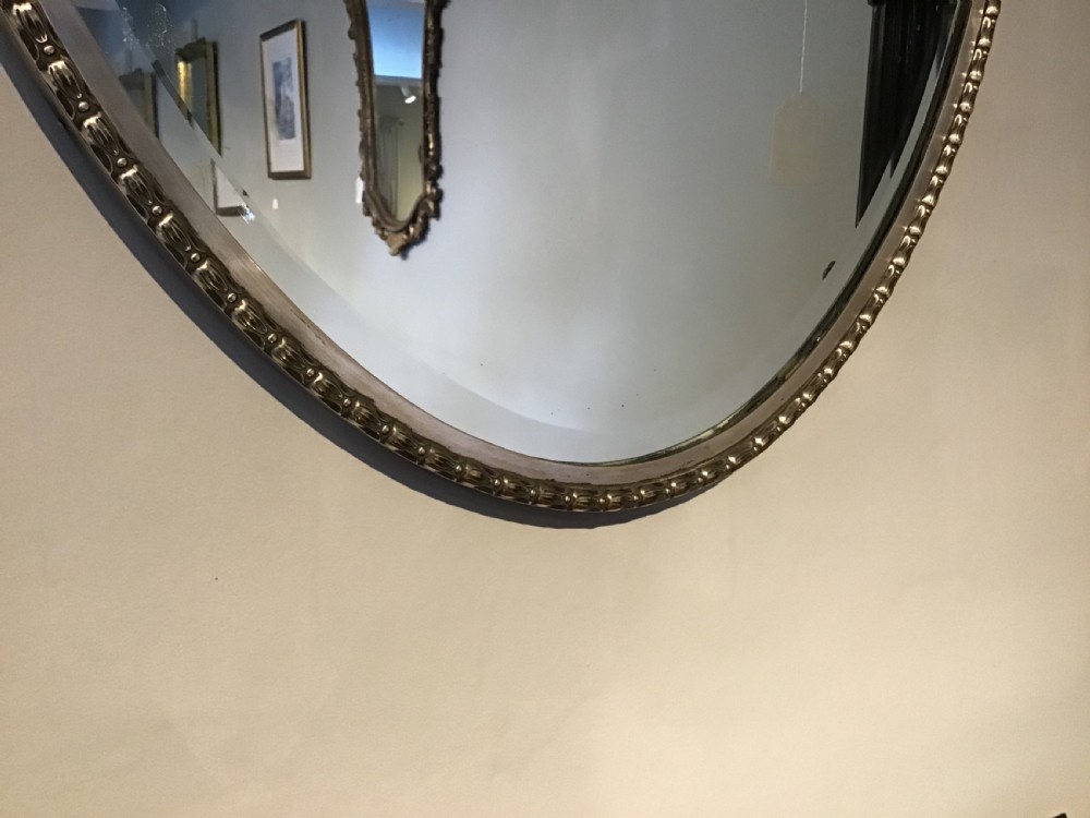 An antique brass framed mirror View II