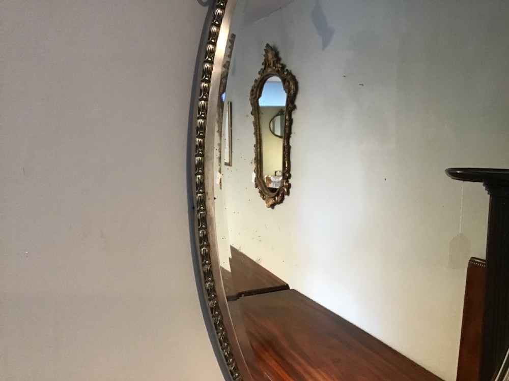 An antique brass framed mirror View III