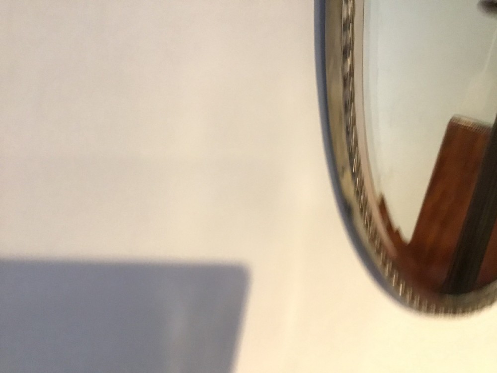 An antique brass framed mirror View IV