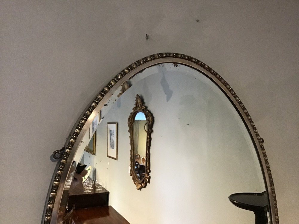 An antique brass framed mirror View V