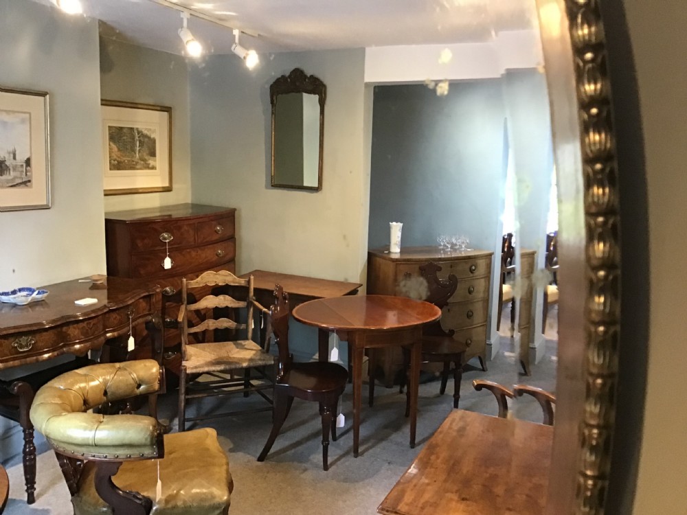 An antique brass framed mirror View VI