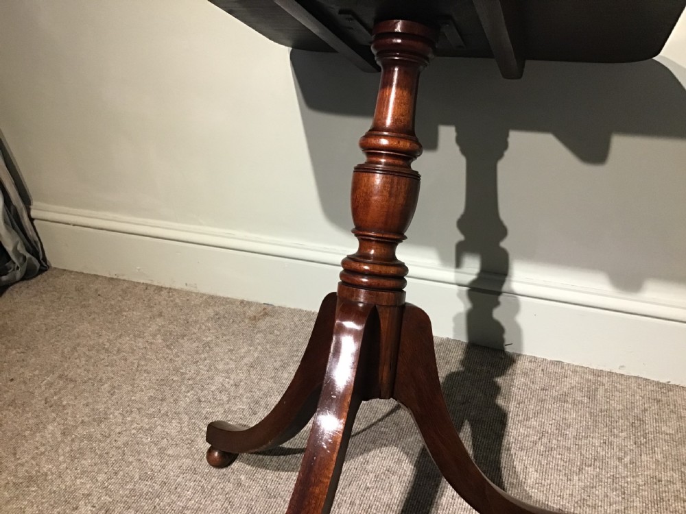A Georgian mahogany tripod table featuring a square top with rounded corners, supported by a turned central pedestal and three splayed legs. View IV