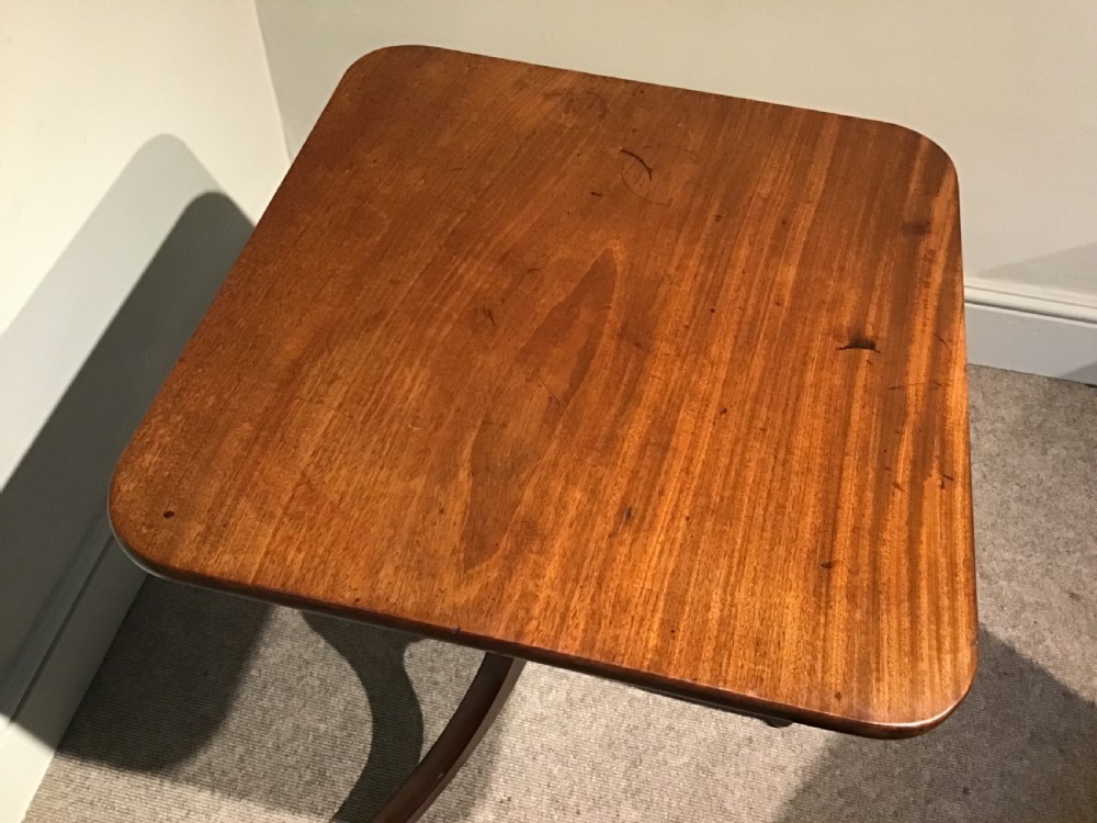 A Georgian mahogany tripod table featuring a square top with rounded corners, supported by a turned central pedestal and three splayed legs. View V